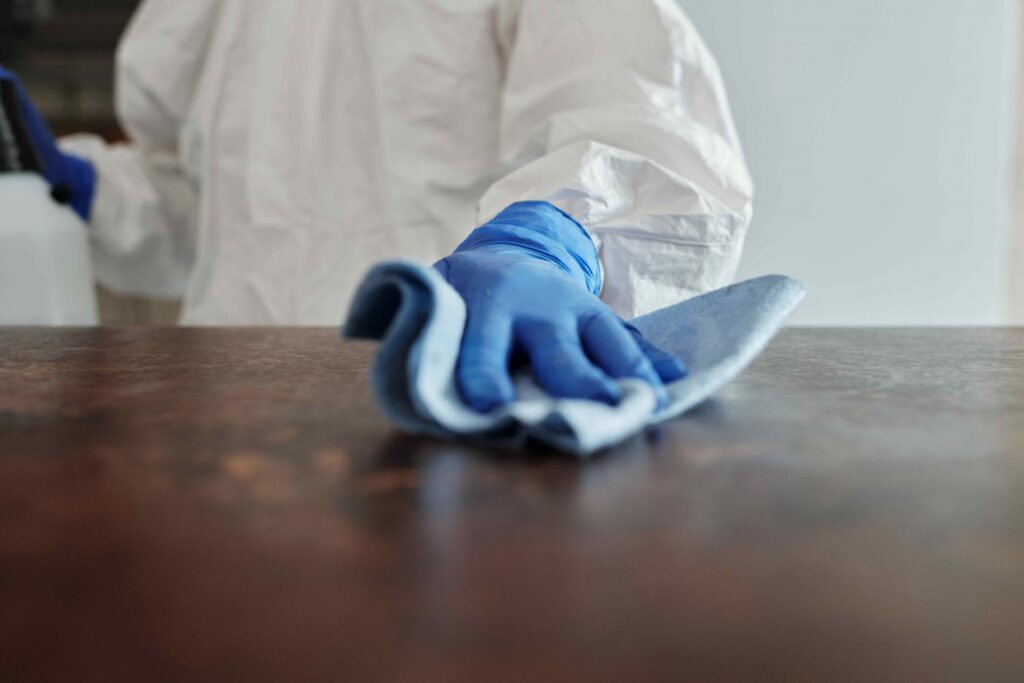 A professional cleaner sanitizing a countertop, symbolizing tips for choosing the perfect deep cleaning service in West Georgia.