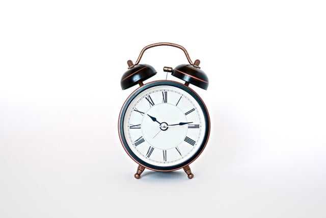 a rustic clock with an alarm