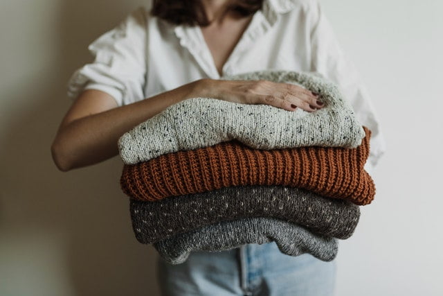 A woman holding clothes