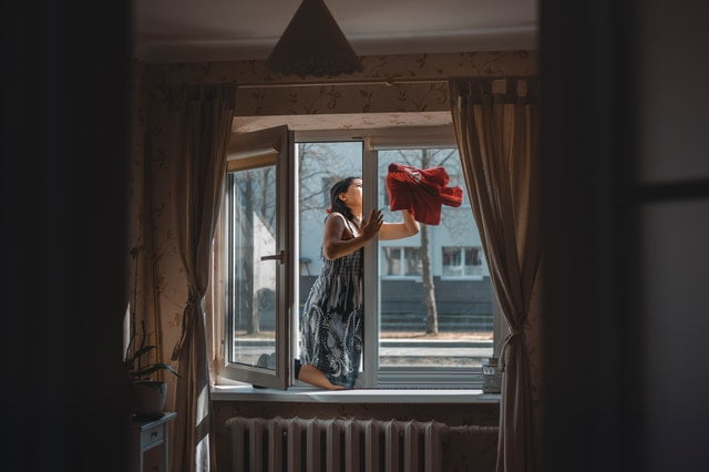 A woman cleaning the windows.