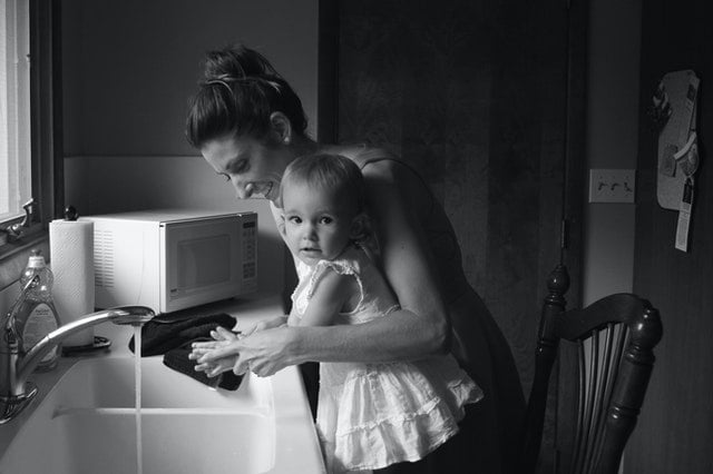 A woman and her daughter cleaning with the help of the best cleaning hacks for busy parents