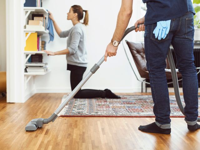 Man and woman cleaning house