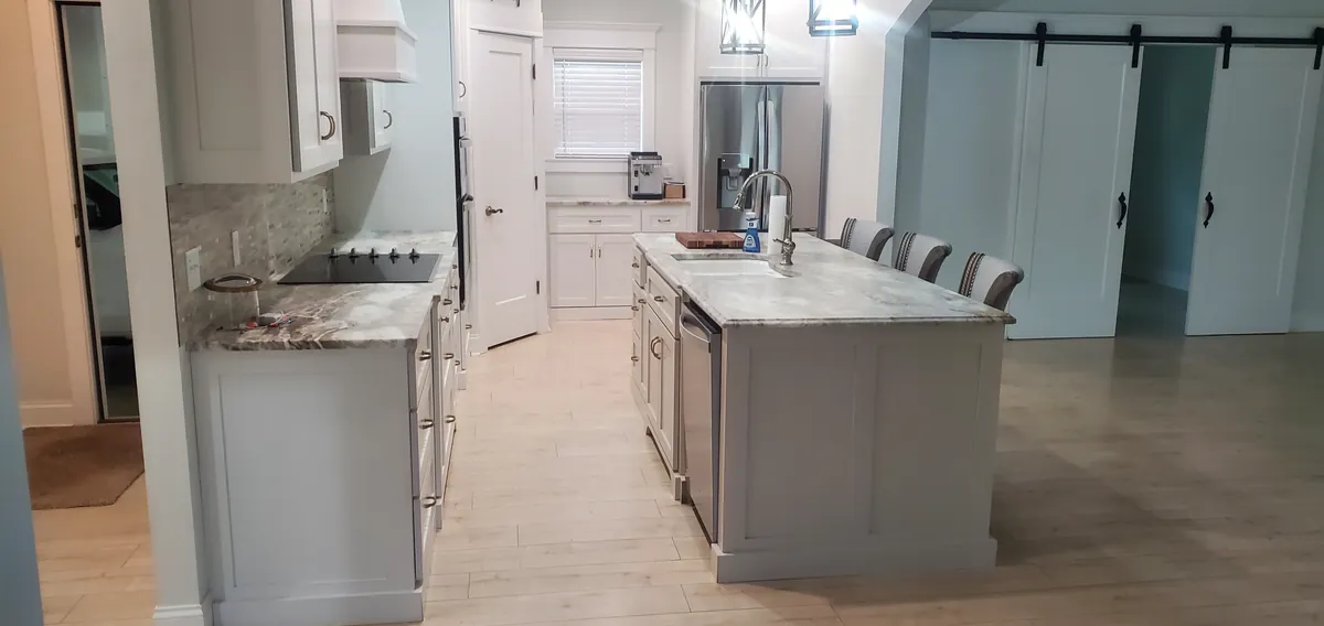 Kitchen with white cabinetry and an island, photographed on a Spotlessly Clean job.