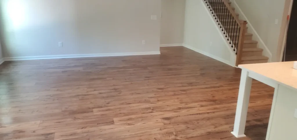 Empty living room with wood flooring and a staircase from the Spotlessly Clean job-photo collection