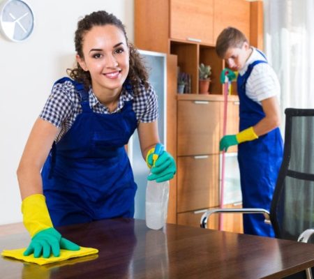Man and woman in blue overalls cleaning house
