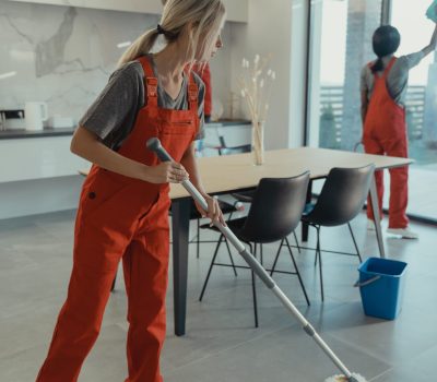two cleaners in overalls cleaning office